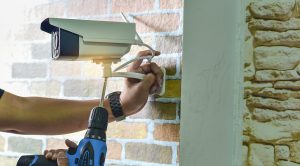 Technician installing CCTV camera for security