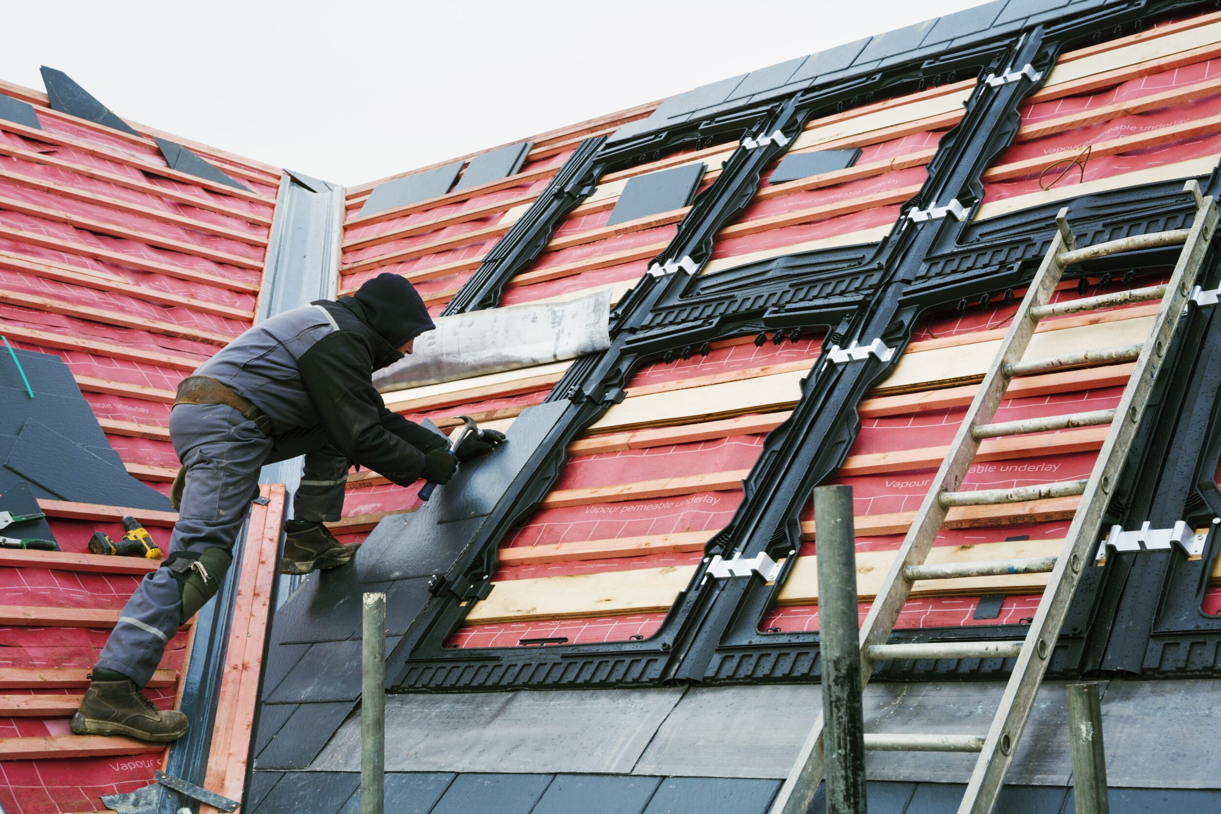 A roofer placing tiles