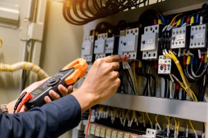 Electrician engineer measuring voltage