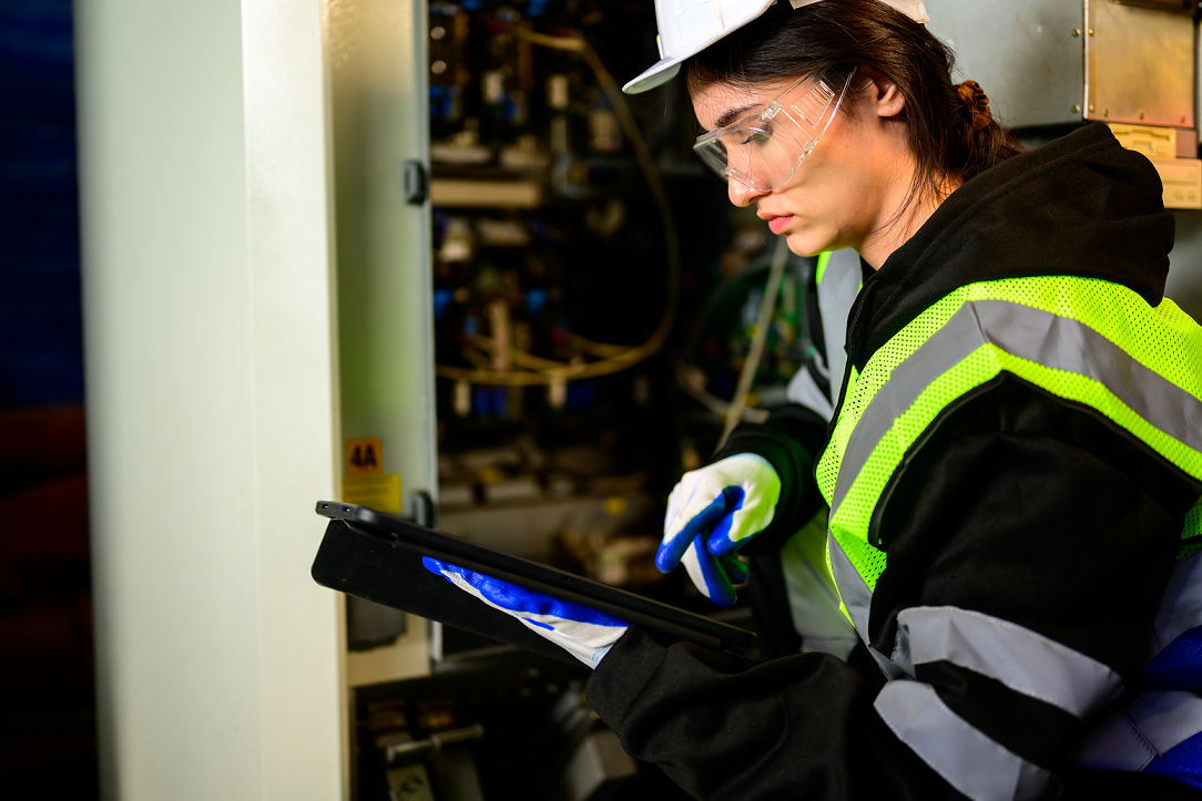 Operations manager inspecting commercial asset with facility maintenance software